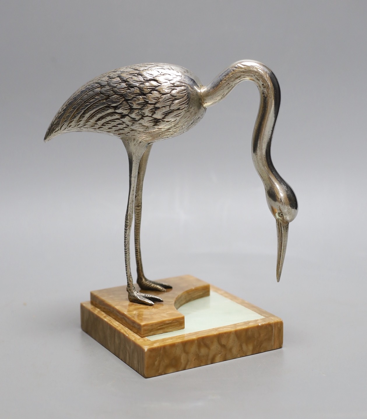 An Art Deco silvered bronze model of a crane, on an onyx base, 18cm